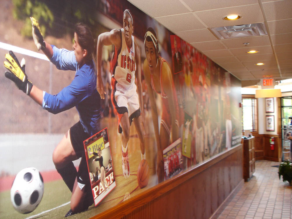 Whether there's a game on or not, everyone who roots for the local teams does so at Raleigh's Backyard Bistro, featuring this wall mural celebrating local college sports.