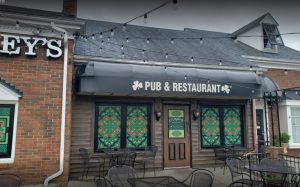 Perforated window film murals give O'Malley's Pub an authentic Irish feel. While allowing patrons inside to still see outside, they also cut the glare of the setting sun every day.