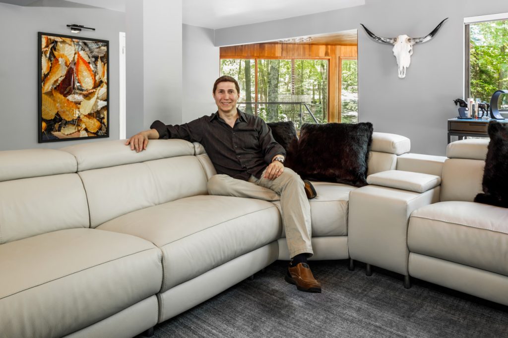 NYC- based interior designer Charlie Bolivar in the living room of his summer home in Pennsylvania