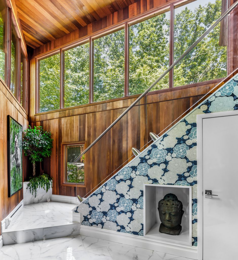 Glass staircase railings let the light shine in throughout the entry area.