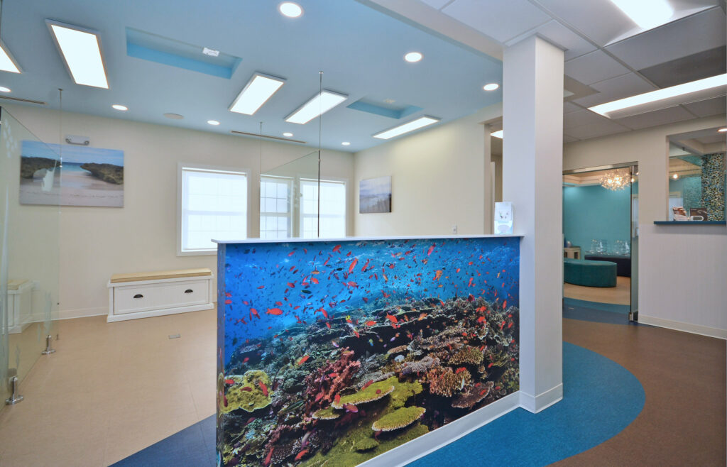 The vibrant hues of this wall mural of tropical fish offer a cheerful distraction as kids enter the treatment area.