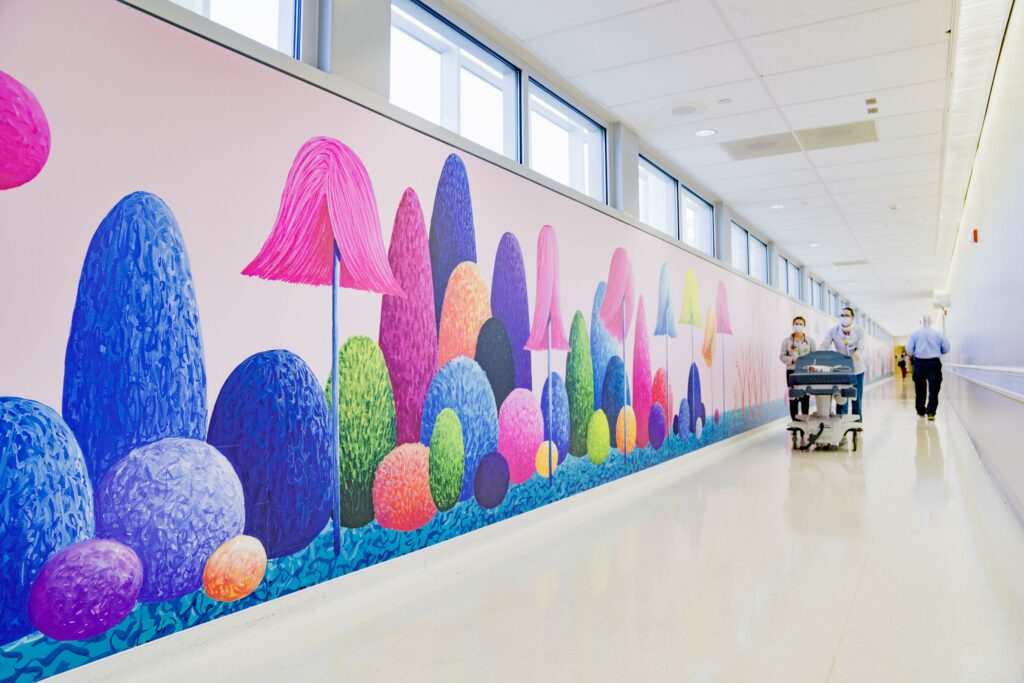 Whimsical and colorful tree murals line this otherwise bleak hallway!