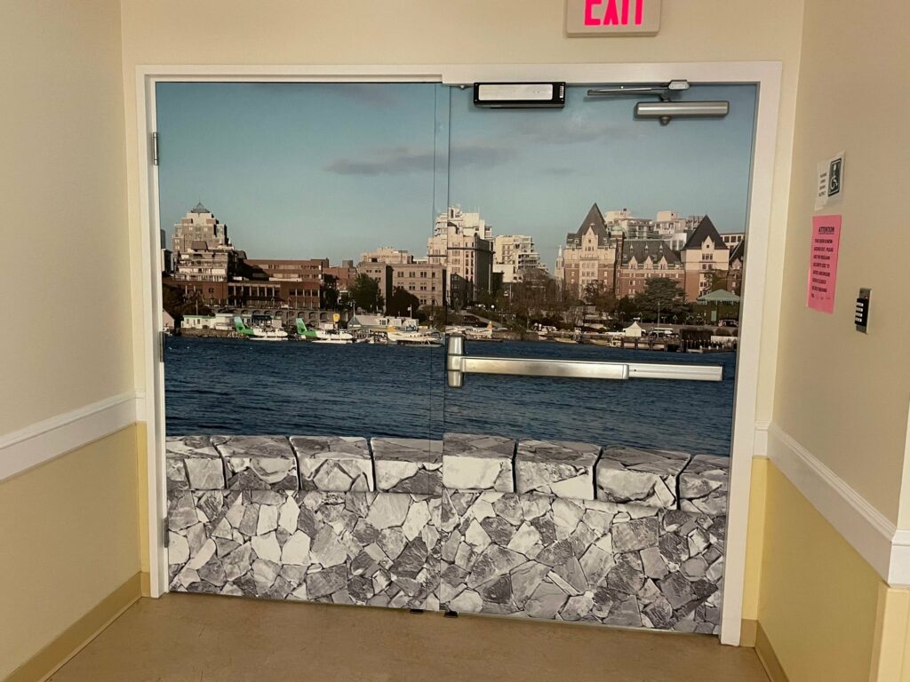 This stone wall around the waterway mural covers exit doors perfectly