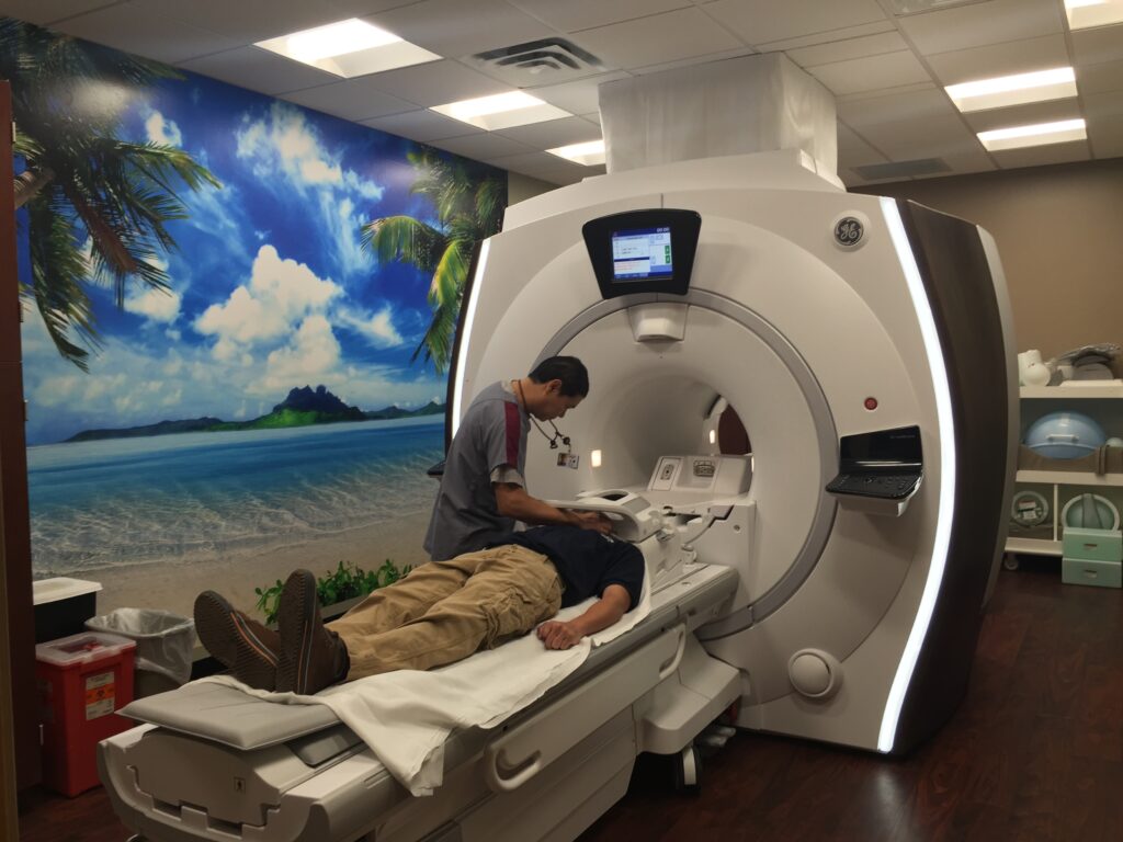 A vibrant island paradise mural beautifies the wall of this MRI  room at North Hills, an award-winning hospital in North Richland Hills, TX.