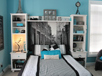 teen's blue bedroom with grayscale mural of narrow road through Parisian street as headboard