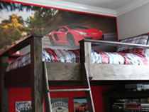 boy's red bunk room with red race car speeding down road in late afternoon wallpaper mural